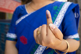 Fototapeta Natura - Voter shows inked finger after cast vote