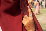 Fototapeta Natura - Voter shows inked finger after cast vote