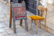 Antique Shop Sign Direction Arrow Wood Board Empty Chair at Street