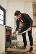 © peopleimages.com - Hygiene, dishwasher and man in kitchen, house and cleaning of plate for bacteria, germs and dirt. Morning, wellness and appliance for washing of dishes, protection and safety in apartment of home