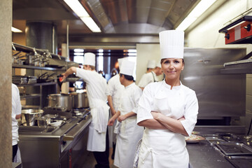 Restaurant, chef and portrait of woman with arms crossed for culinary service, job and pride in kitchen. Fine dining, person and face of cook in food industry for catering, career and hospitality