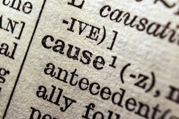 Word cause on dictionary page, macro close-up