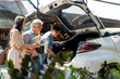 © CandyRetriever  - Asian couple with elderly father put potted plants and flower in car trunk together after buying plant at street market on summer vacation. Family relationship and senior people mental health care.