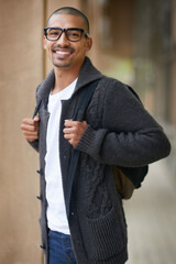 Wall Mural - Smiling, student and portrait in hallway with backpack, glasses and casual fashion in college for lecture. Gen z man, happy and ready on campus for lesson, class and learning for education or degree