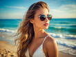 Beautiful young woman on the beach. Happy girl in Sunglasses