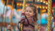 Little girl riding a carousel at a fair and smiling at the camera.