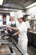 © peopleimages.com - Team, meat and chef with frying pan in kitchen for catering service, fine dining or prepare dish. Hospitality, presentation and employees for cooking meal, food industry or dinner in restaurant