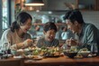 © Surachetsh - Happy family breakfast hour, father, mother, son, and daughter sit at a table filled with food in a dining room.