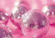 Indoors, shiny disco balls toned pink, space for text