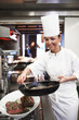 Dish, chef or woman in kitchen in restaurant for lunch, fine dining or dinner presentation. Business, cafe or female expert for catering, serving or ingredients for culinary cuisine or food as career