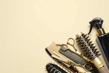 Wall Mural - Different hairdresser tools on beige background, flat lay. Space for text