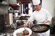 Chef, steak and woman fry in kitchen of restaurant for dinner, lunch or supper with hospitality. Career, catering and culinary worker cooking meat in pan for fine dining food or in gourmet cafe.