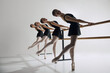 Harmony in motion. Beautiful teen girls, ballet dancers attending dance studio, practicing against grey background. Elegance. Concept of ballet, art, dance studio, classical style, youth