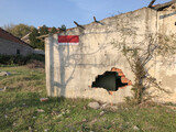 Fototapeta Tulipany - abandoned house with hole on the wall