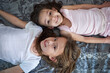 Children, portrait and top view on bed as sisters with childhood bonding, connection or happiness. Kids, friends and face with youth smile in home from above for family love, relaxing or together