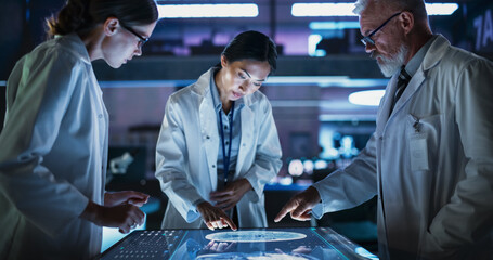 Aufkleber - Modern Hospital Medical Research Center: Diverse Colleagues Gathered Around Interactive Touch Screen Table With MRI Scans Of Brain On Display. Three Doctors Discussing Innovative Brain Tumor Treatment