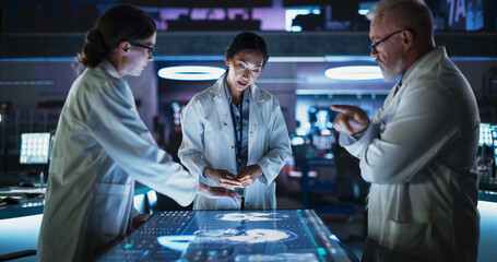 Poster - Modern Hospital Medical Cancer Research Center: Diverse Scientists Gathered Around Interactive Touch Screen Table With CT Scans Of Brain On Display. Three Doctors Discussing Brain Tumor Treatment.