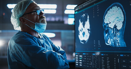 Aufkleber - Medical Hospital Research Laboratory: Caucasian Male Neurosurgeon Looking At TV Screen With Brain MRI Scans Of Patient, Analyzing, Preparing For Complicated Neurosurgery, Wearing Surgical Gown.