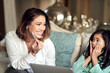 Happy mother, child and surprise with credit card on laptop for online shopping or payment at home. Mom and young daughter with smile for debit, banking or eccomerce on computer on living room sofa