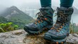 Hiker s scenic view from mountain top with lake and river, feet in hiking shoes on cliff