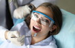 Young smiling beauty woman in dentinst office portrait. Prevention of toothache and tooth decay concept.