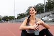 © Rawpixel.com - Happy woman athlete drinking water and rest