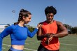 © Rawpixel.com - Male and female athletes looking at a fitness tracker data