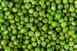 Fresh garden peas forming a vibrant green background texture: healthy, eating, vegetables fresheners nutrition balance diet.