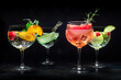 Fancy cocktails with fresh fruit. Many gin and tonic drinks with ice at a party, on a black background. Alcohol with herbs and flowers