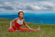 Portrait of cheerful smiling sporty girl doing yoga fitness exercise outdoor in beautiful mountains landscape, Elevated fitness: Young woman embraces a mountain workout for holistic summer health