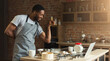 © Prostock-studio - African-american man baking cookies at home kitchen