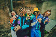 Vintage aesthetic fashion. Young people, friends wearing colorful athletic sportswear, trendy accessories posing in striking pose against urban backdrop. Concept of 90s, fashion, youth culture