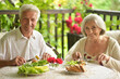 Happy senior couple having diner and posing at home