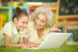 Portrait of grandmother and daughter using laptop