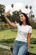 © Rawpixel.com - Hispanic woman in white tee, taking selfies, casual wear