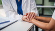 © NanSan - Monthly health check-ups and counseling sessions are provided to an elderly Asian woman by a Caucasian female caregiver, offering support, advice, and motivation.