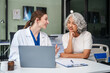 © NanSan - Monthly health check-ups and counseling sessions are provided to an elderly Asian woman by a Caucasian female caregiver, offering support, advice, and motivation.