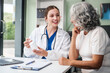 © NanSan - Monthly health check-ups and counseling sessions are provided to an elderly Asian woman by a Caucasian female caregiver, offering support, advice, and motivation.