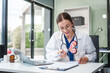 © NanSan - Caucasian woman sits at a desk, kidney model, gallstones, glomerulonephritis, acute and chronic kidney disease, infectious diseases, abnormal ureters, cysts, and urinary system cancer.