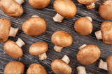 Fototapeta Mapy - brown mushroom pattern on wood background top view