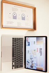Poster - Laptop, strategy guide and steps for planning on a desk in an office from above for business project. Computer, blog or online article on screen in an empty workplace for research on company growth