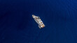 Aerial top view made by drone of big yacht in the blue sea.