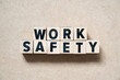 Alphabet letter block in word work safety on wood background