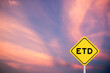 Yellow transportation sign with word ETD (abbreviation of estimated time of departure or the estimated time of delivery) on violet color sky background