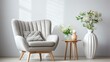 A stylish gray armchair and a wooden table with a vase of flowers in a bright room with white walls