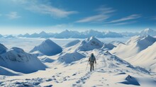 A Lone Hiker Traverses A Snowy Mountain Landscape