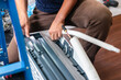 Repairman service for repair and maintenance of air conditioners, Technician team install new air conditioner