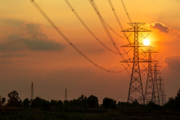 silhouette electricity pole, electricity pylons technology during sunset time background with copy s