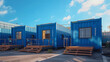 shipping containers converted into modern living spaces, some with wooden platforms and windows, in a parking lot on a bright sunny day under a blue sky