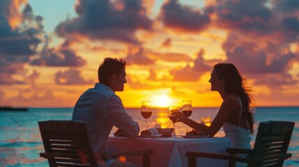 Wall Mural - A couple celebrating their anniversary with a romantic dinner at sunset